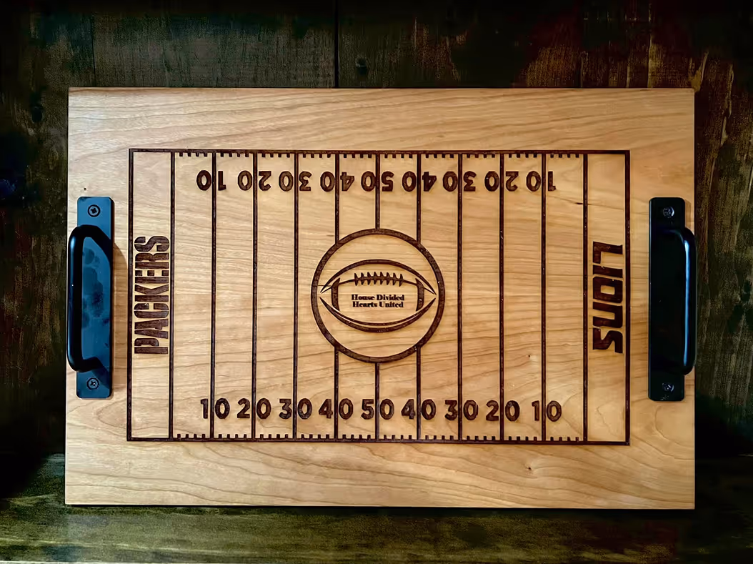 Wooden tray with football field engraving showing Packers and Lions team names and yard lines.