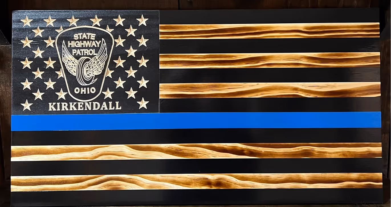 Wooden American flag with blue stripe and Ohio State Highway Patrol emblem with name Kirkendall.
