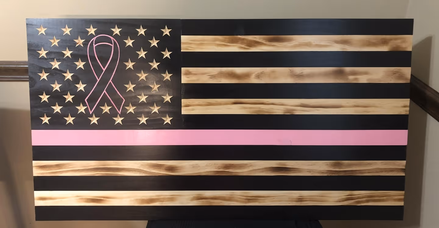 Black and natural wood American flag with a pink breast cancer ribbon and a pink stripe.
