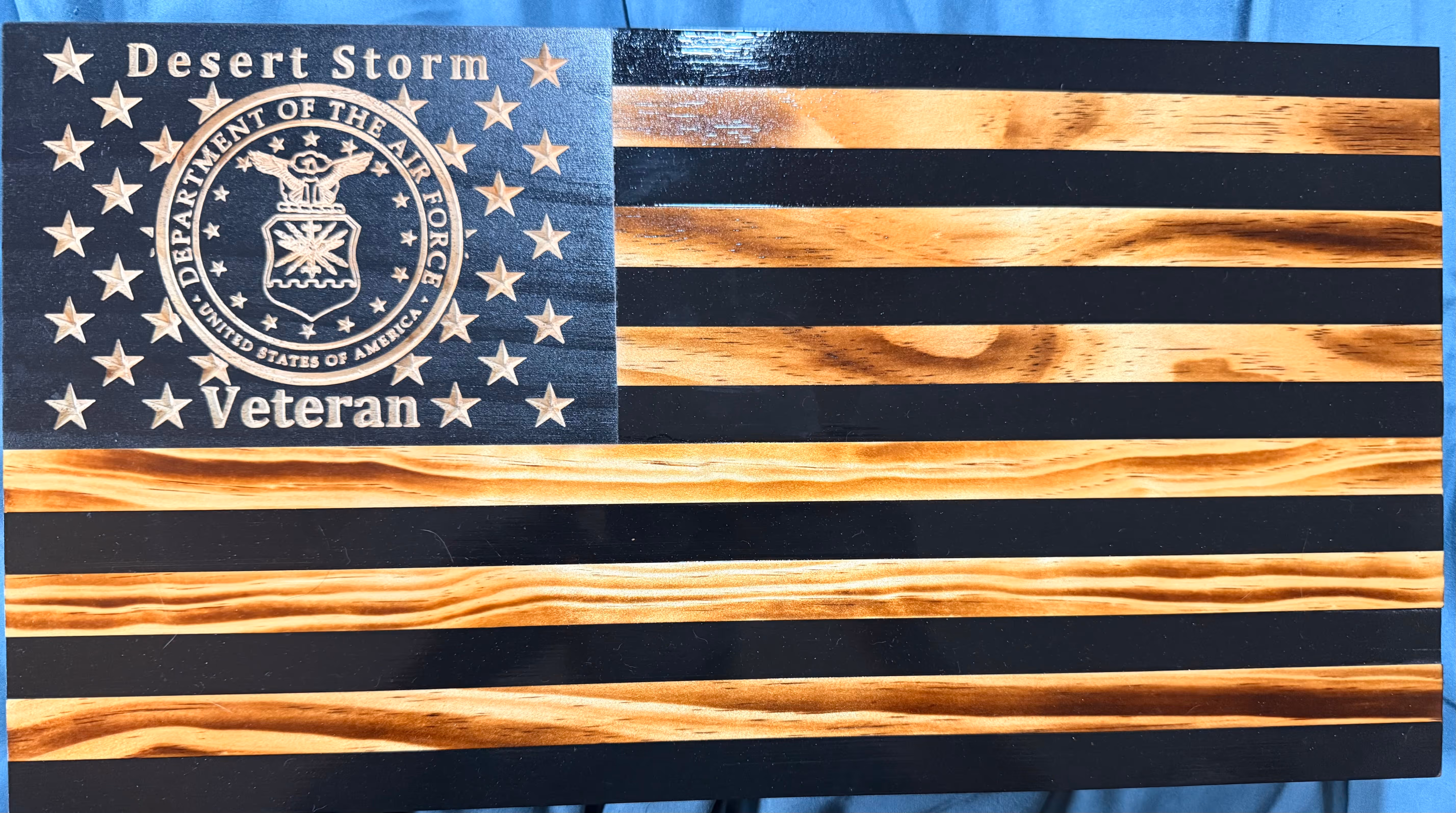Wooden American flag with Air Force seal, stars, and text 'Desert Storm Veteran'.