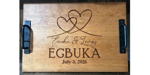 Wooden tray engraved with two overlapping hearts, names Emeka & Latrey, and date July 3, 2026.