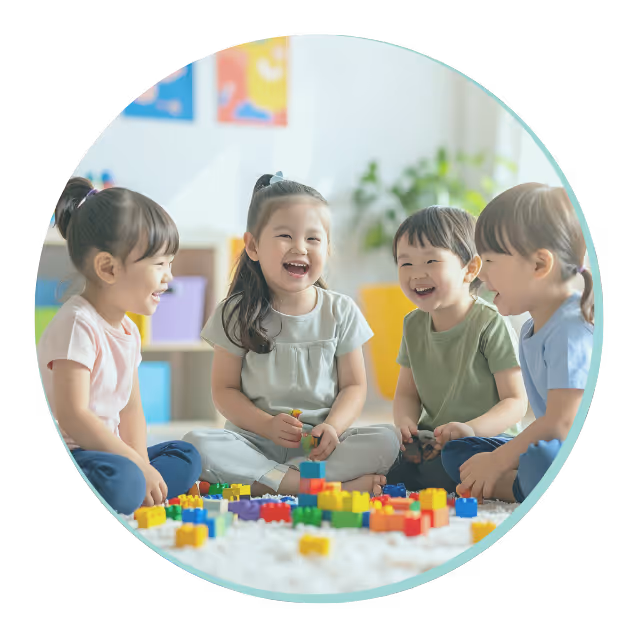 Colorful stacked children's building blocks in various shapes and colors against a circular teal background.