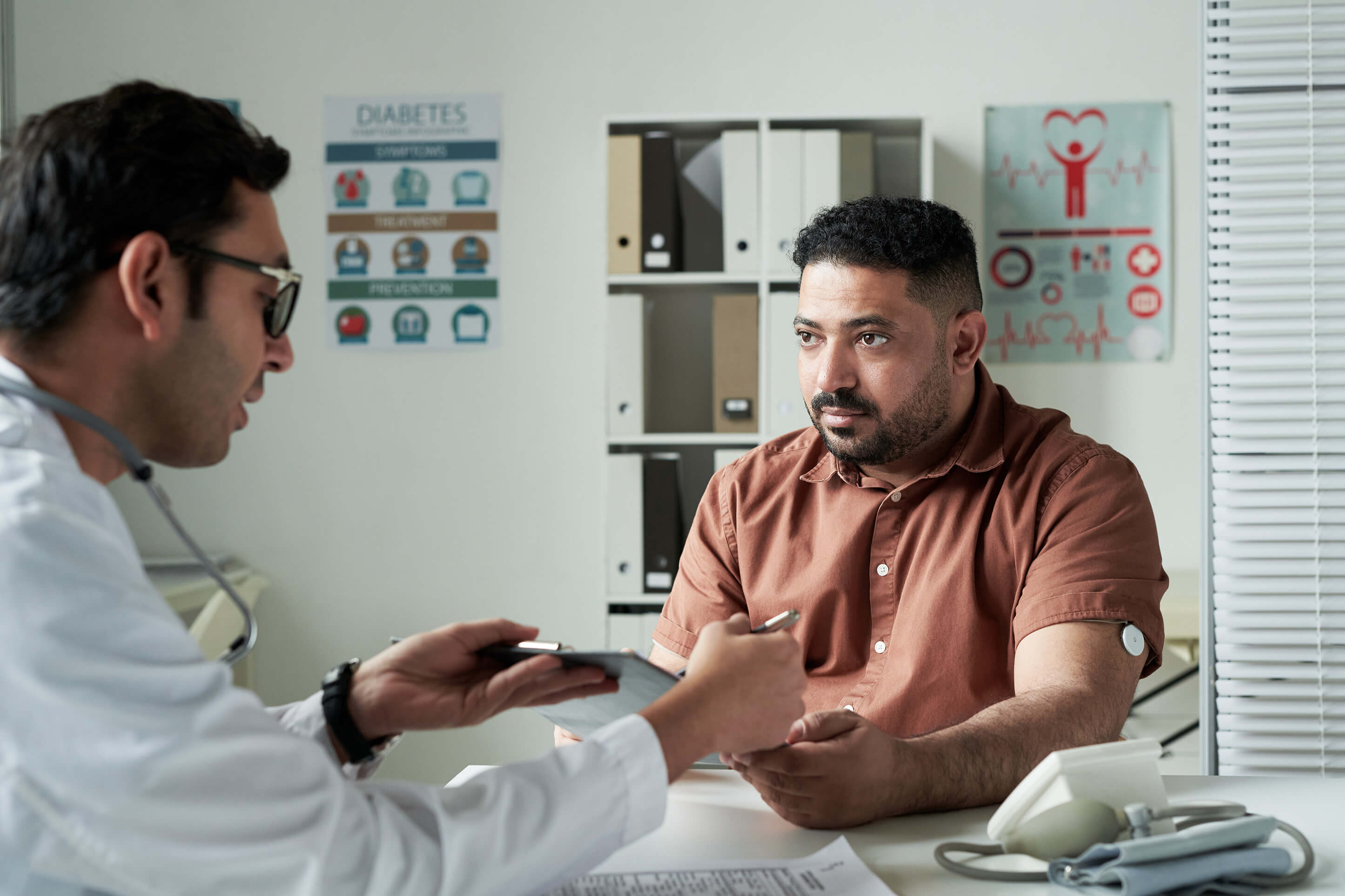 A man consulting his doctor about medication-assisted treatment for opioid addiction and alcohol use disorder