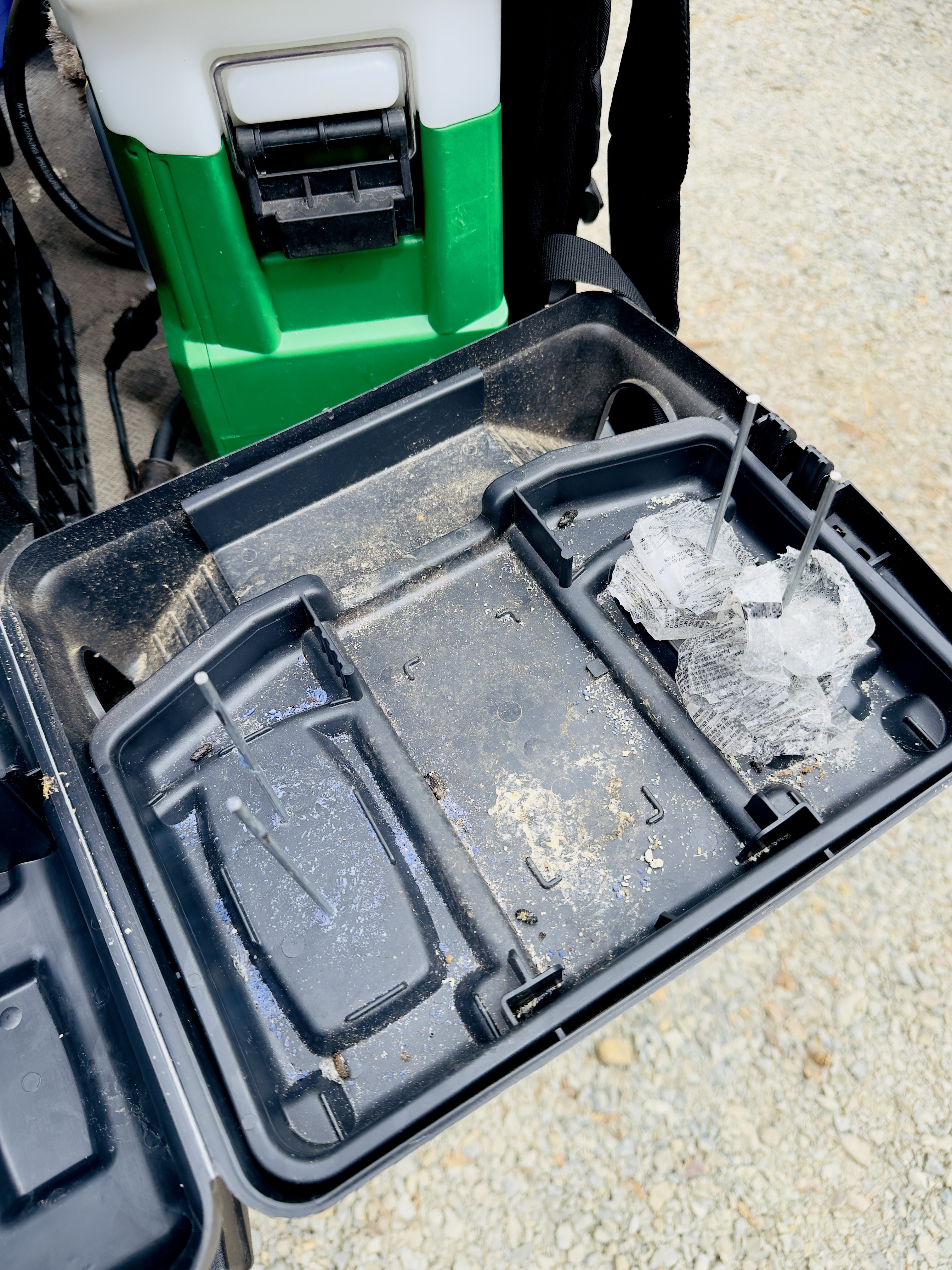 Opened exterior bait station showing signs of rat feeding activity during a routine check