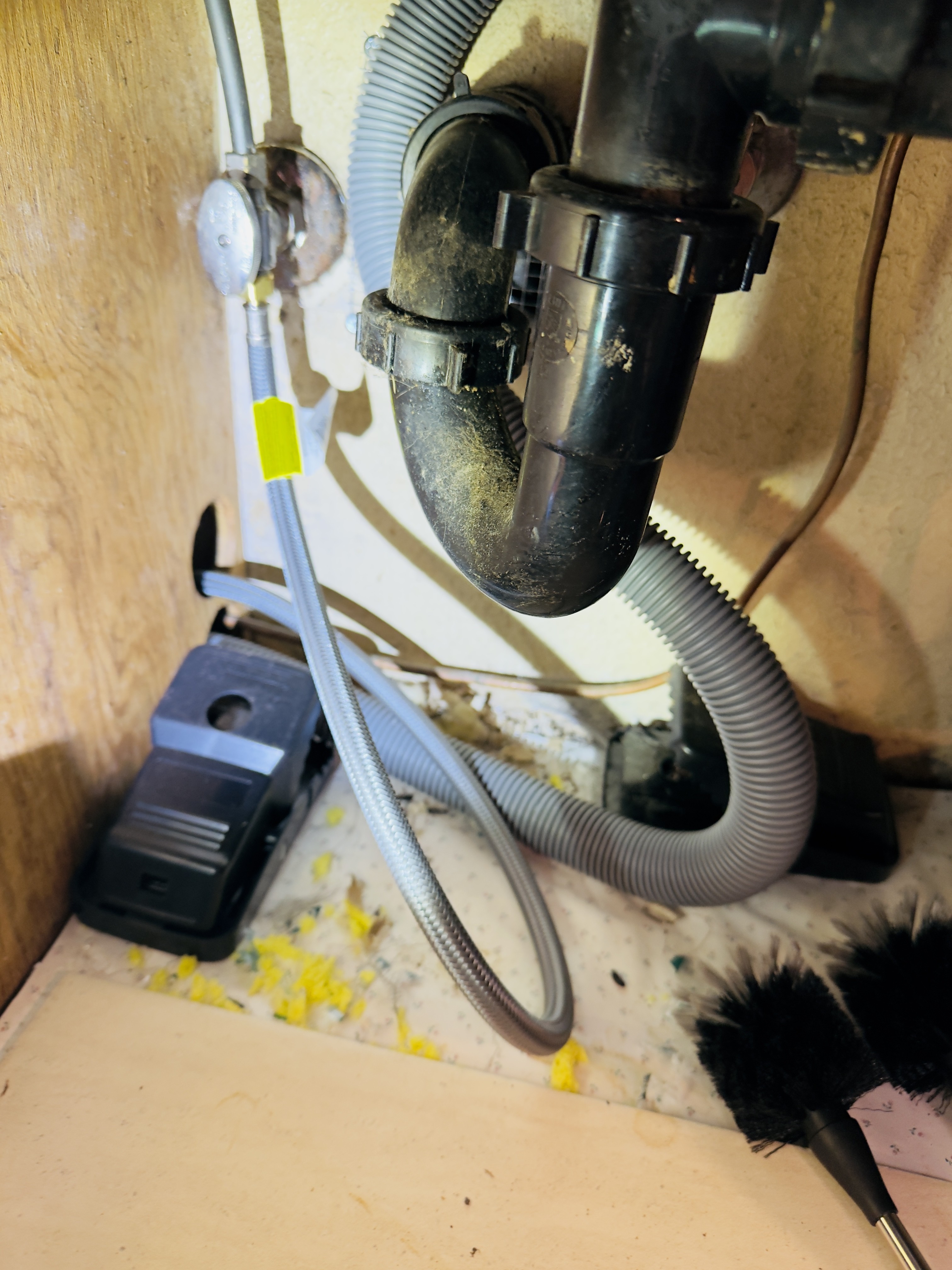 Two traps placed beneath a kitchen sink after securing a rodent opening