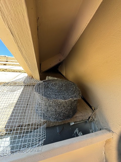 Roll of Xcluder rodent exclusion fill fabric and a sheet of 1/4-inch hardware cloth set beneath an eave before exclusion work