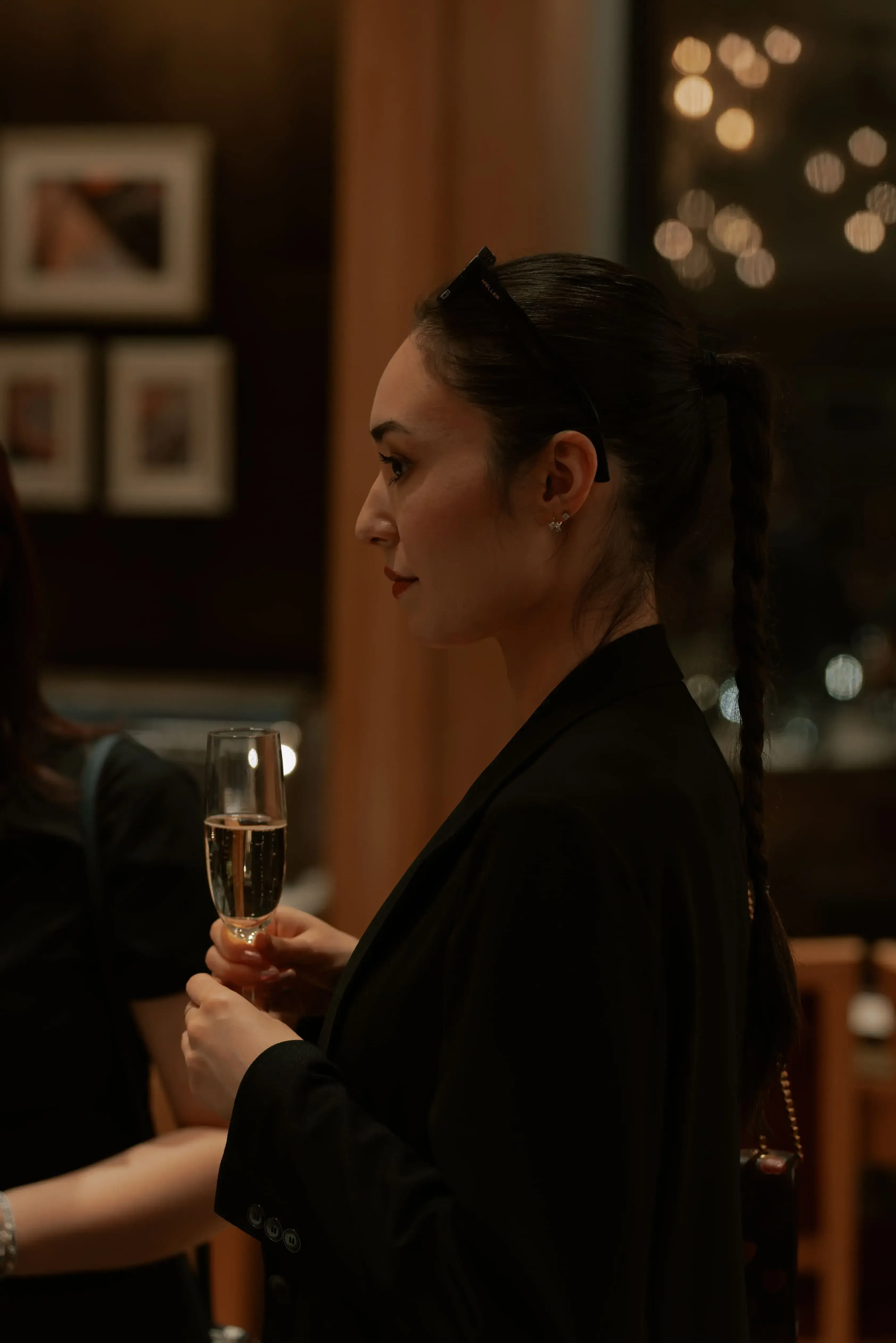 Elegant woman holding a wine glass at a luxurious event