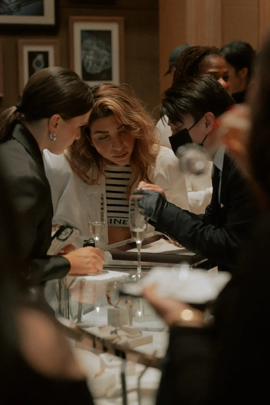 Guests shopping at a premium jewelry counter during an event.