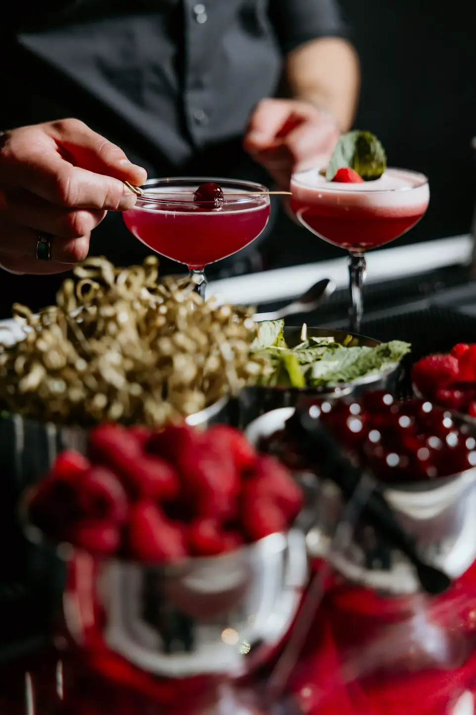 Assorted fruits and berries in glasses at an event buffet