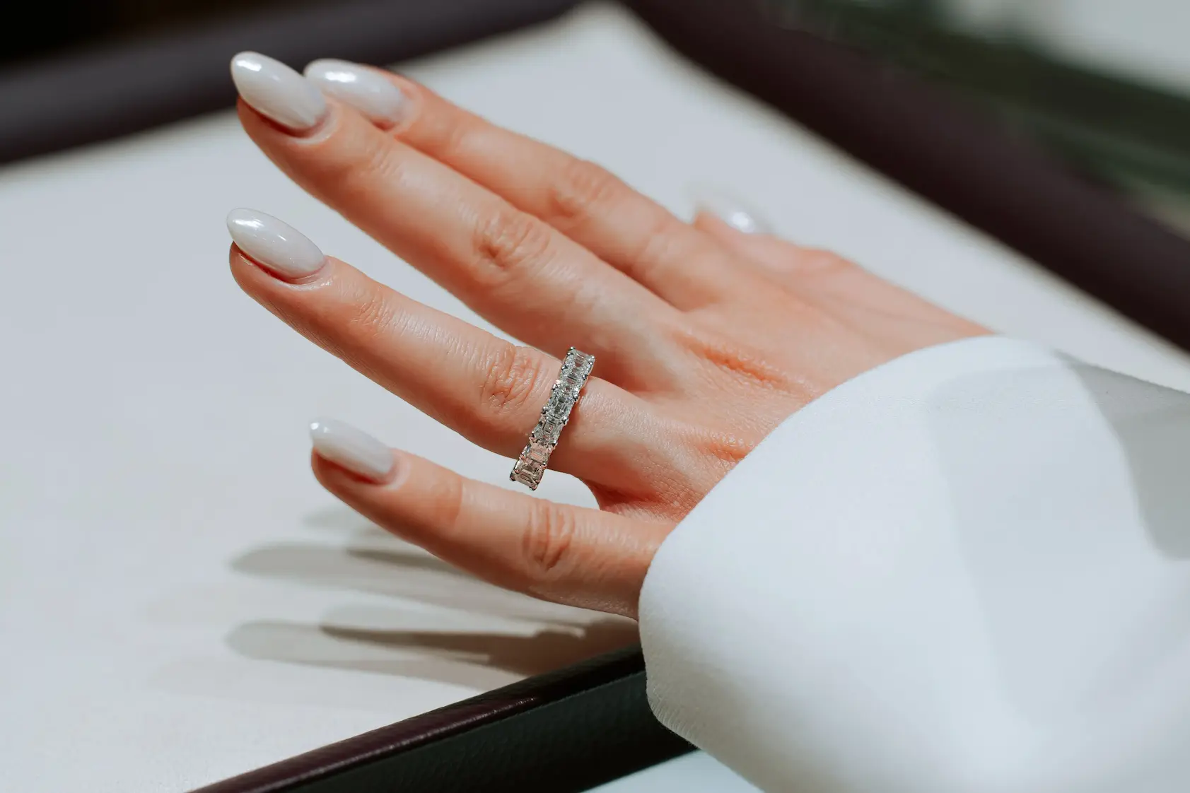 Close-up of a hand with a wedding ring at an event.