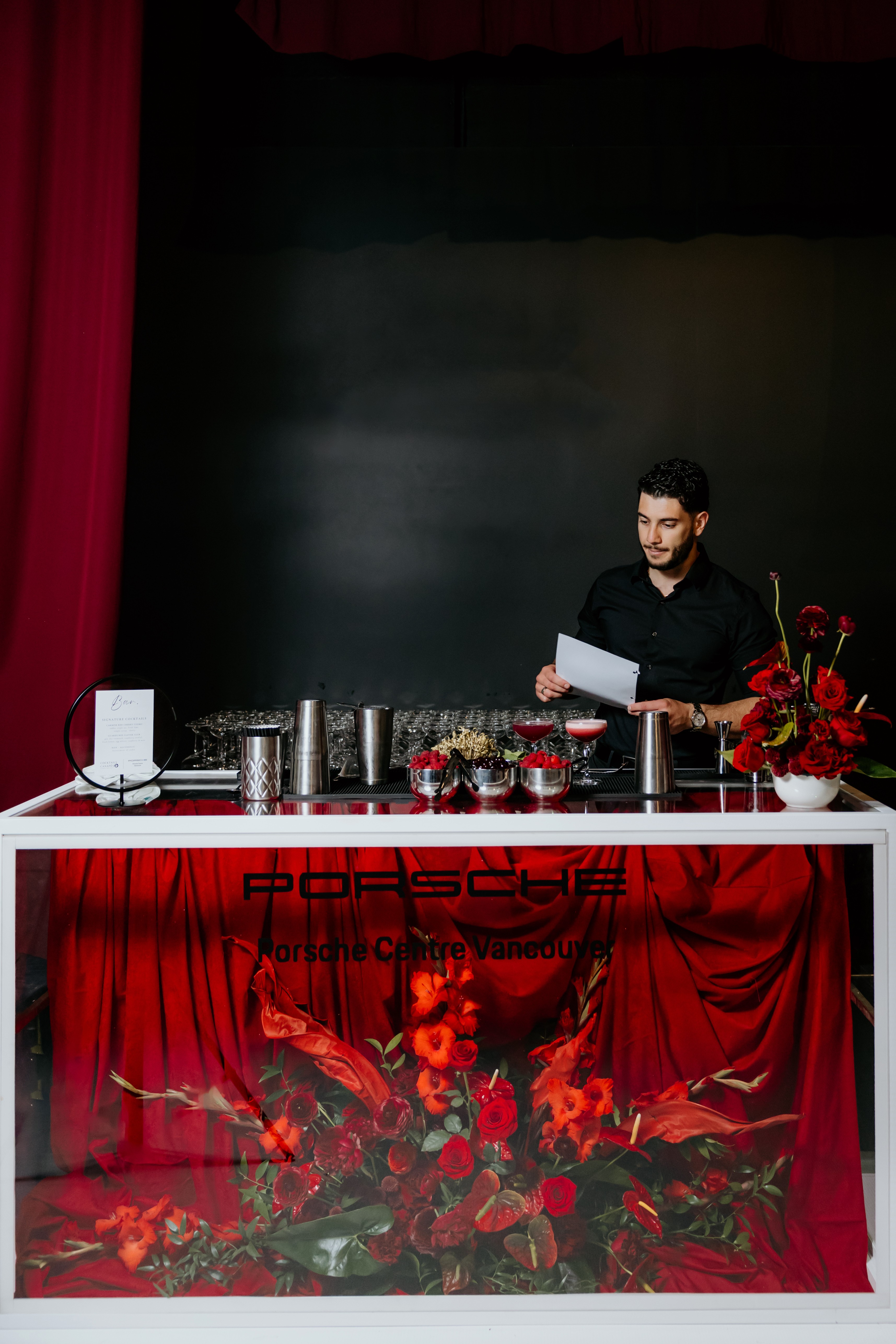 The bartender is making cocktails for the event.