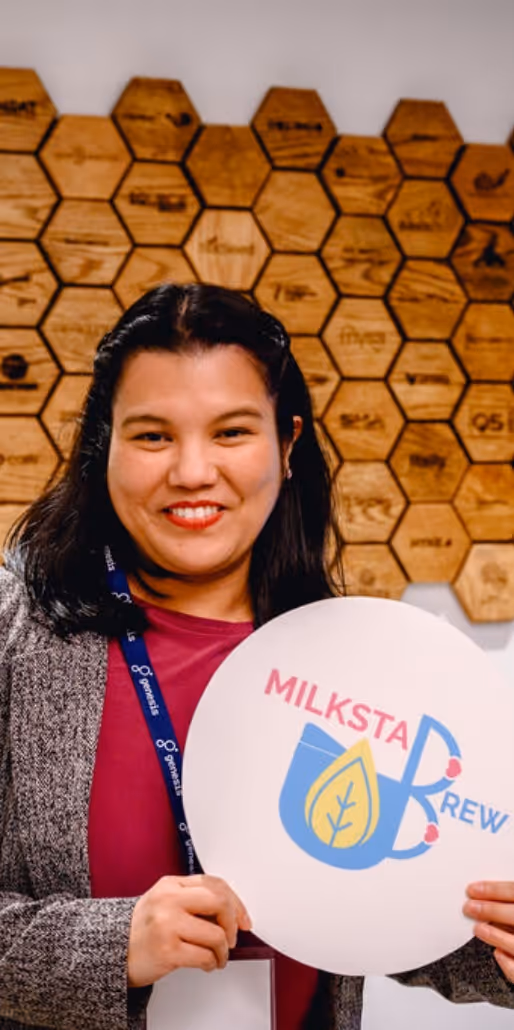 Founder of Milksta holding up her sign.