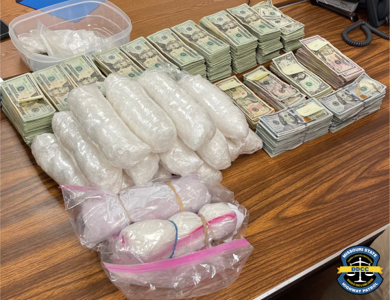 Drugs and money lay on a table.