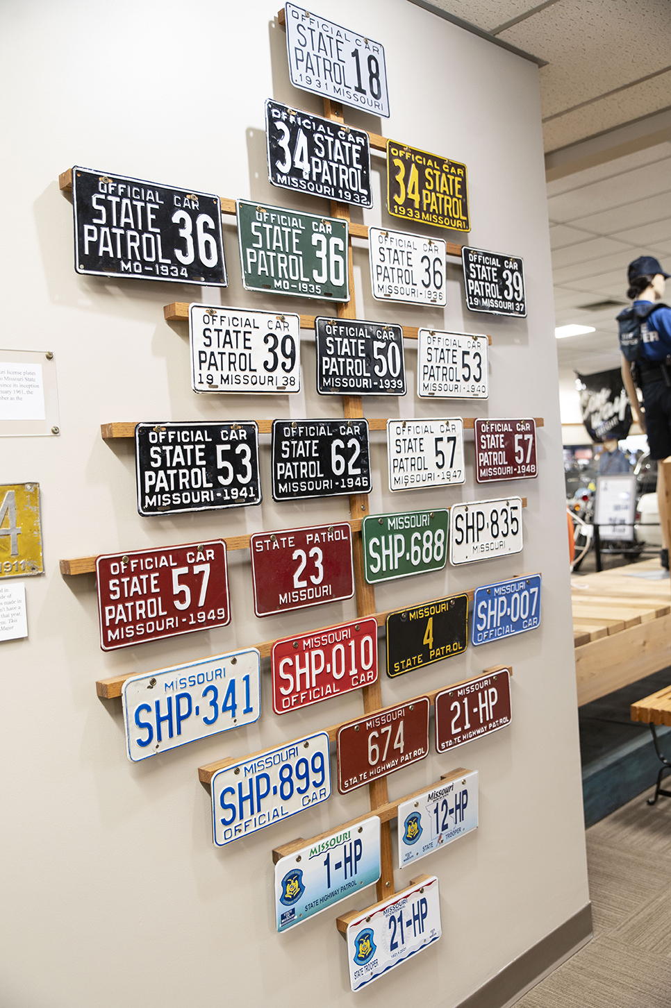 A display of old Patrol license plates hangs on the museum wall.
