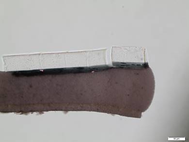 Cross section of a paint chip showing four distinct layers.