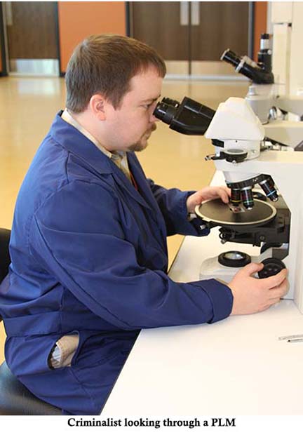 A criminalist looking through a polarized light microscope.