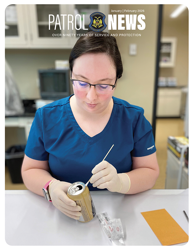 January February 2026 Patrol News. A woman from the Crime Lab inspects a sample.