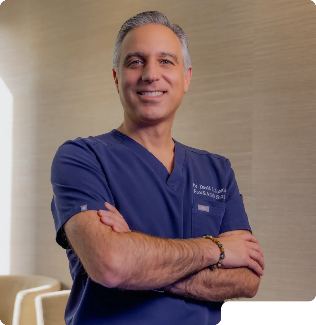 Dr. Soomekh in blue scrubs smiling at the camera