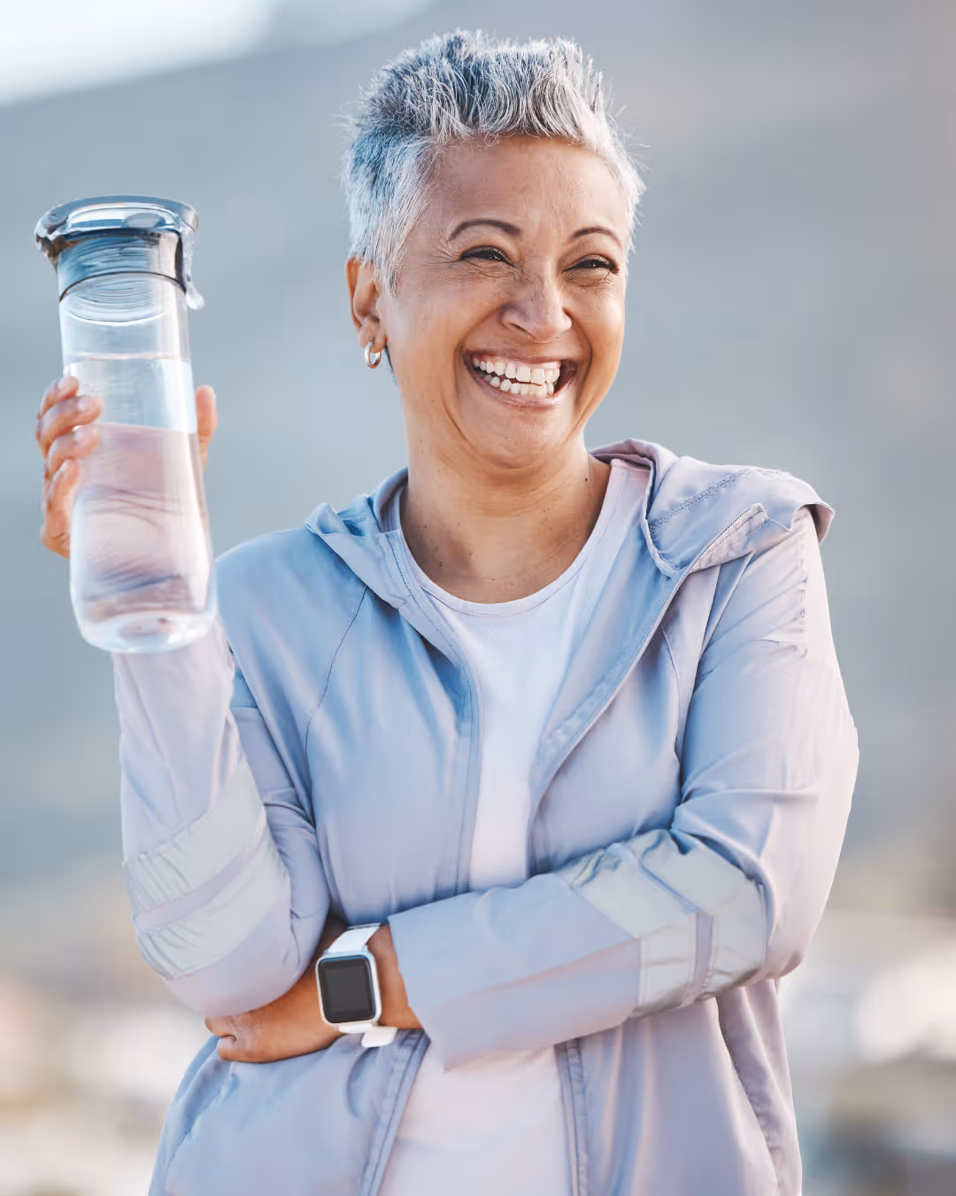 Woman drinking water from a clear glass, emphasizing hydration as part of Belle’s GLP-1 nutrition guidance.