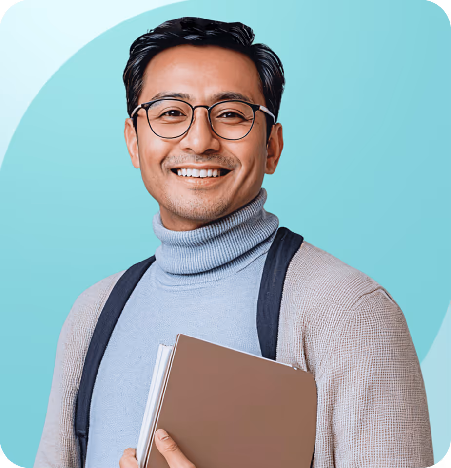 Smiling young man wearing glasses, a light blue turtleneck, and beige cardigan holding a folder against a teal background.