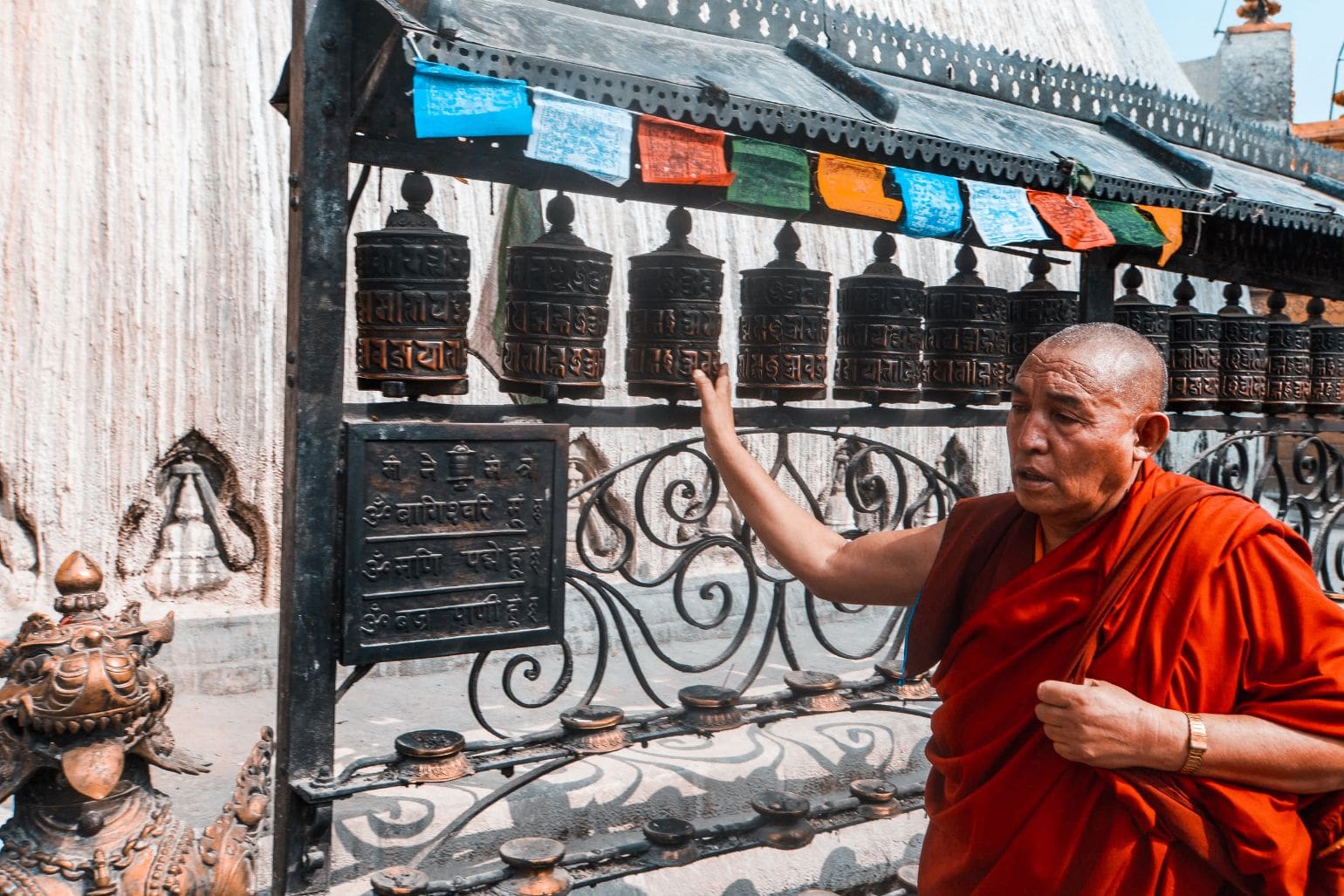 Monk engaging in daily cultural practice at a temple.
