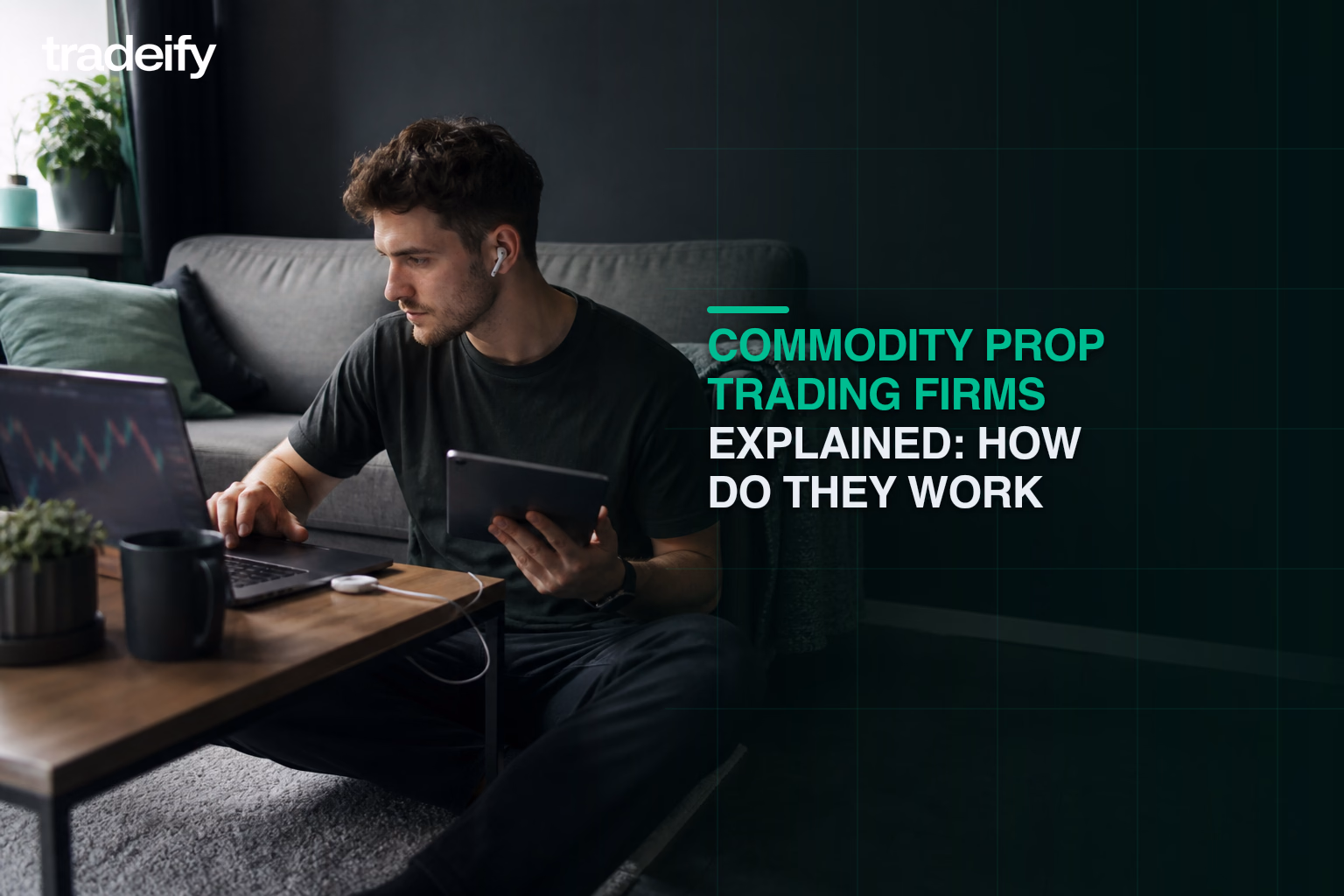 Young commodity futures trader comparing devices from a lived-in apartment floor workspace