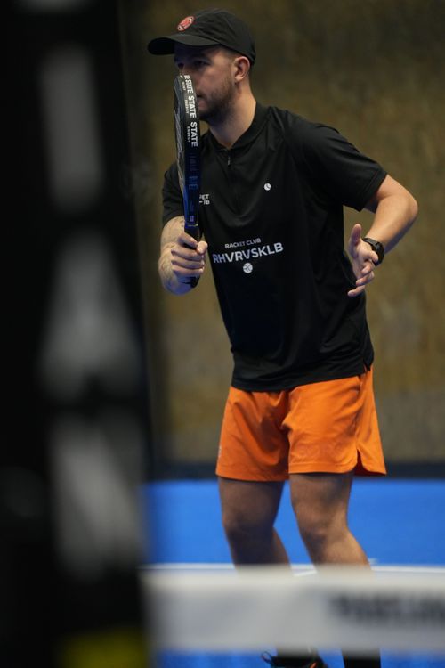 Padel balls arranged on a blue turf court