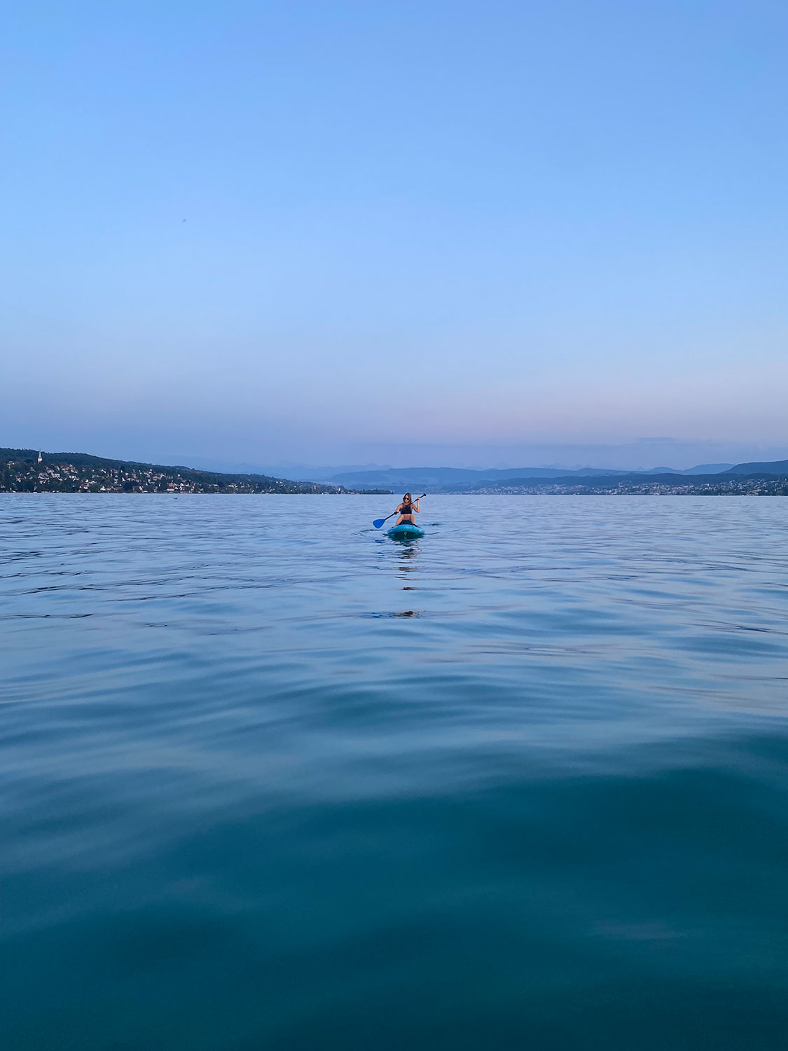 Lake Zurich on an SUP with mountain background
