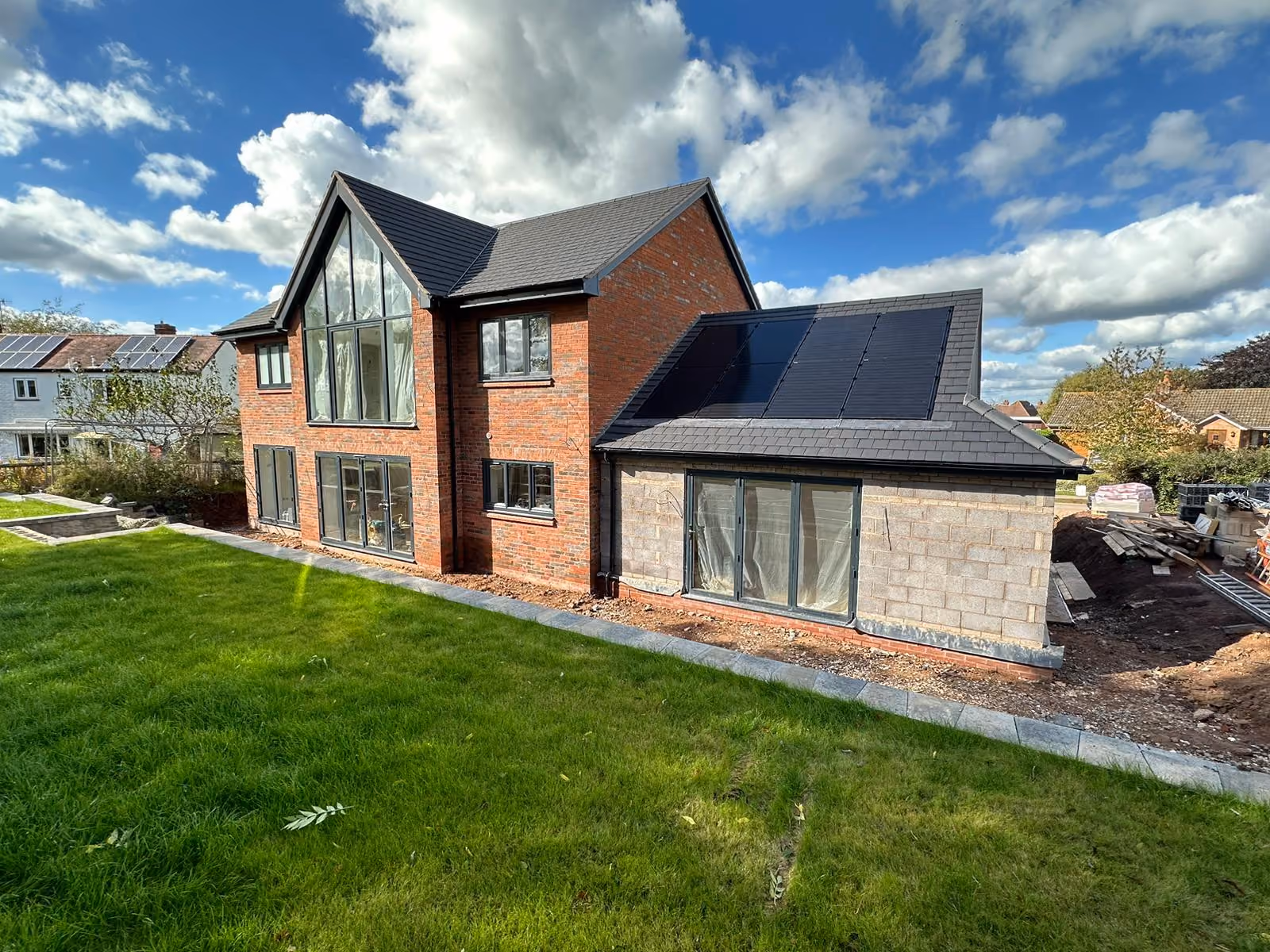 Black-framed patio doors installed on a residential rear extension