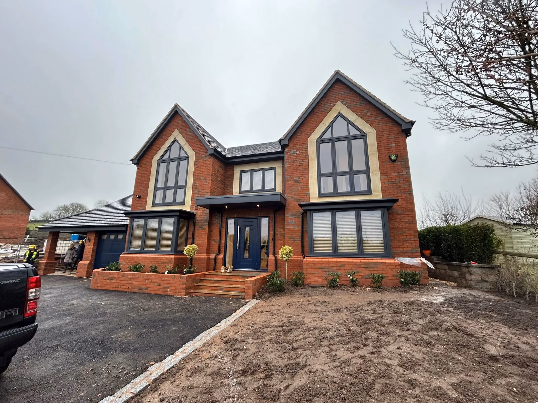 Modern black-framed windows installed on a house exterior