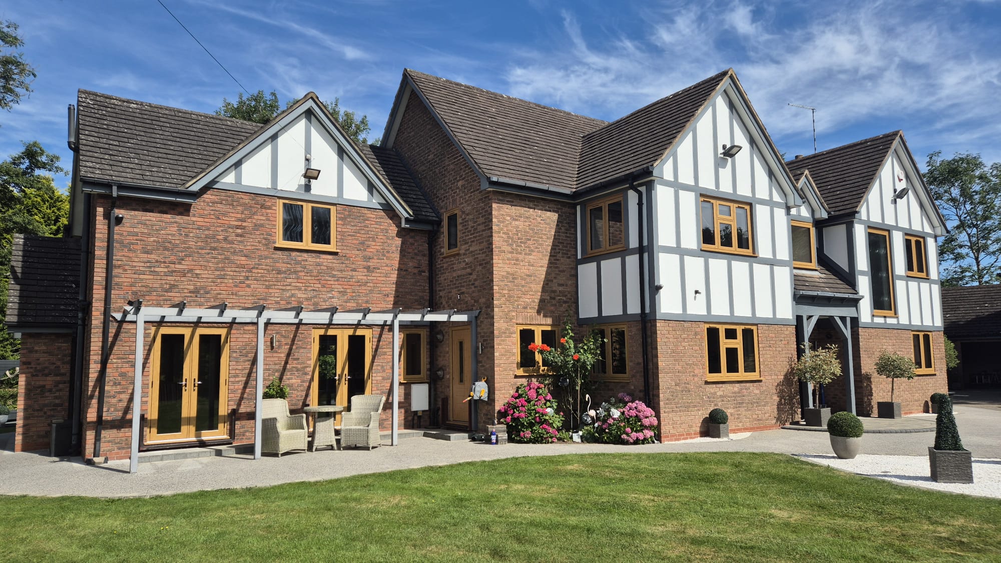 Large two-story property with wooden-framed residence windows