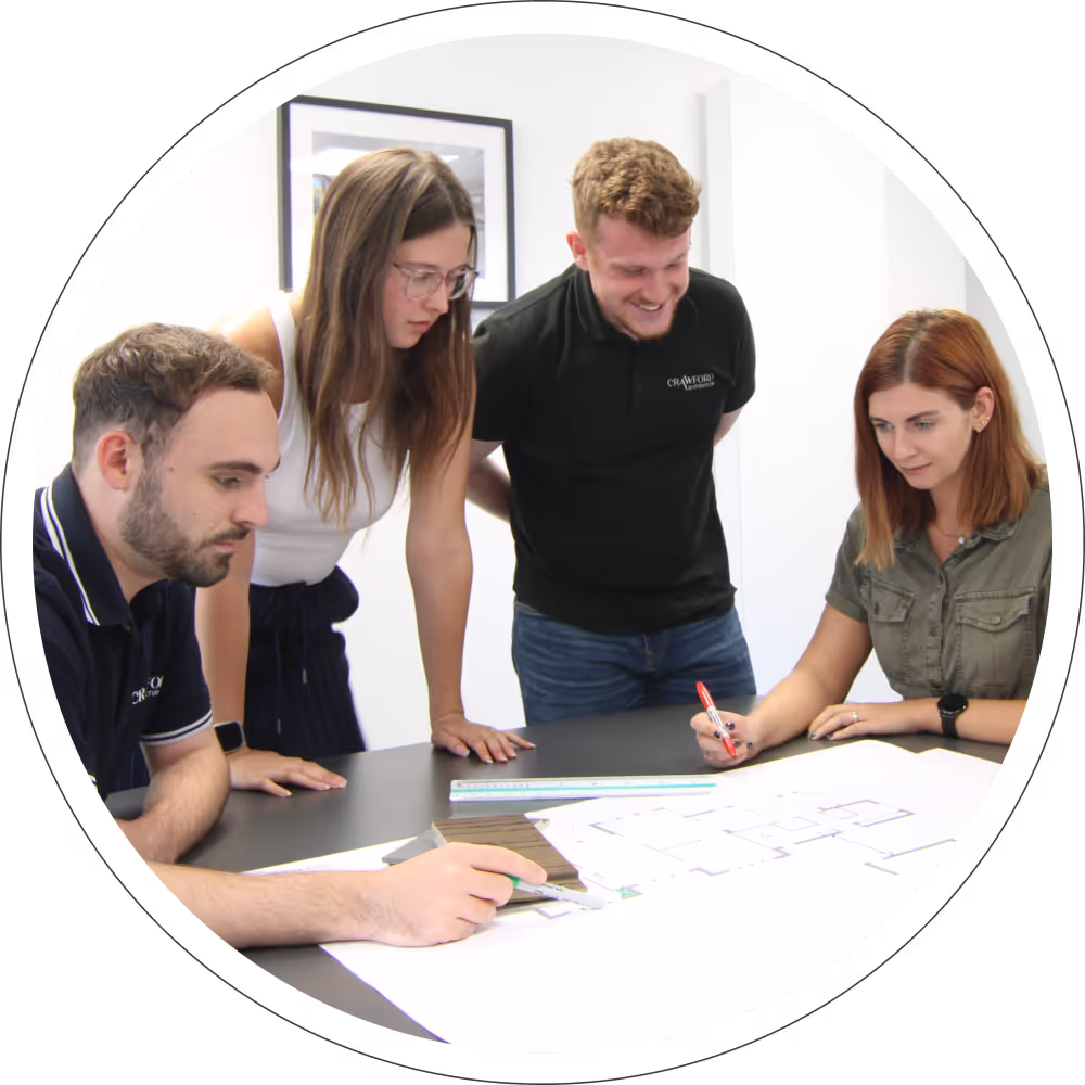 A team of Architects surrounding floorplans