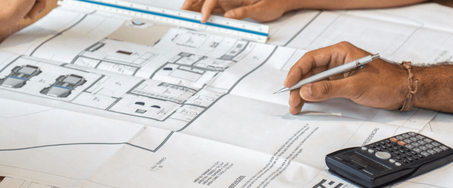 Architects reviewing detailed house blueprints - CRE Investing 