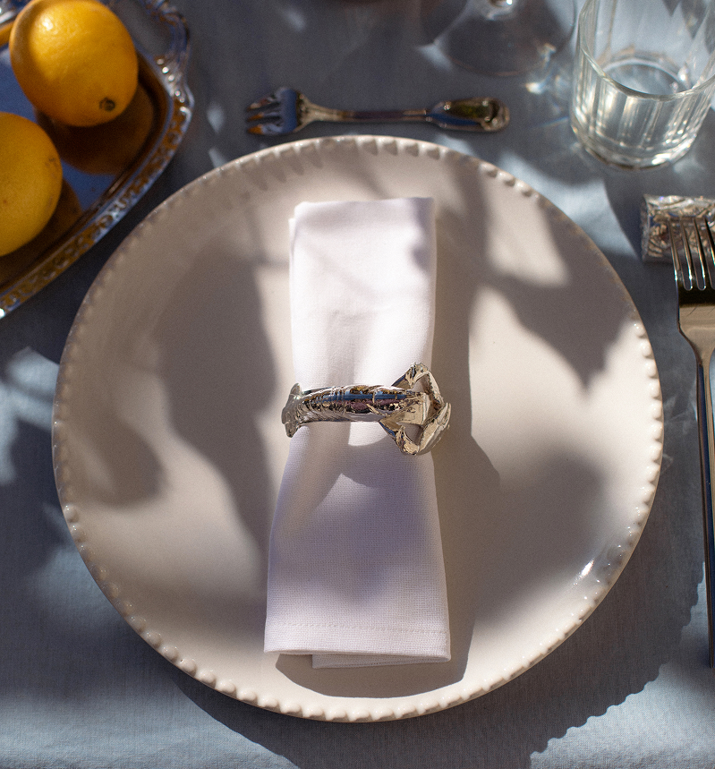 Luxury tableware made in France. Silver napkin ring in the shape of a oyster, brass napkin ring, bronze napkin ring, luxury table setting and tablescaping. Perfect for luxury tables, hospitality flatware, design or decor objects for the table. 