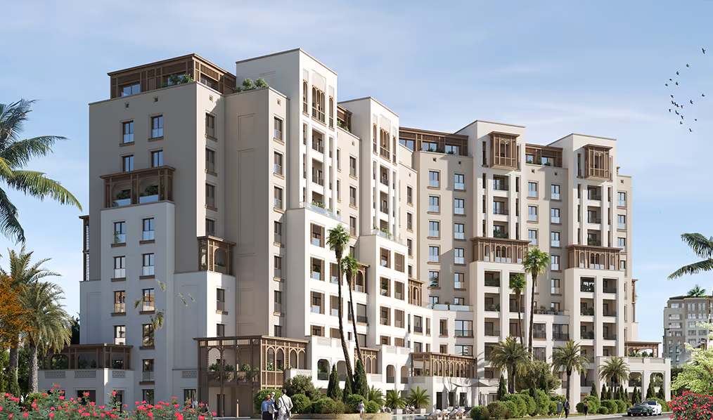 A large white building with palm trees in front of it - arabian ranches