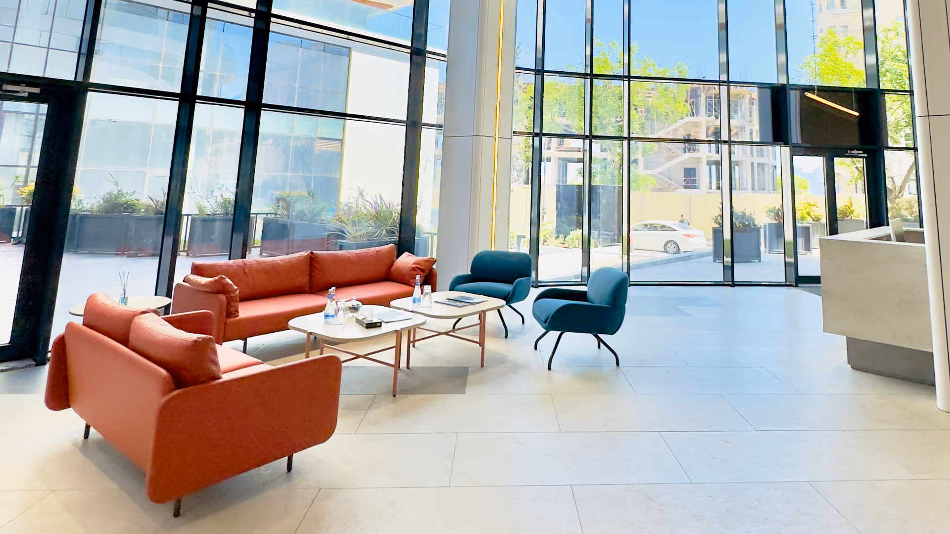 A living room filled with furniture and large windows.