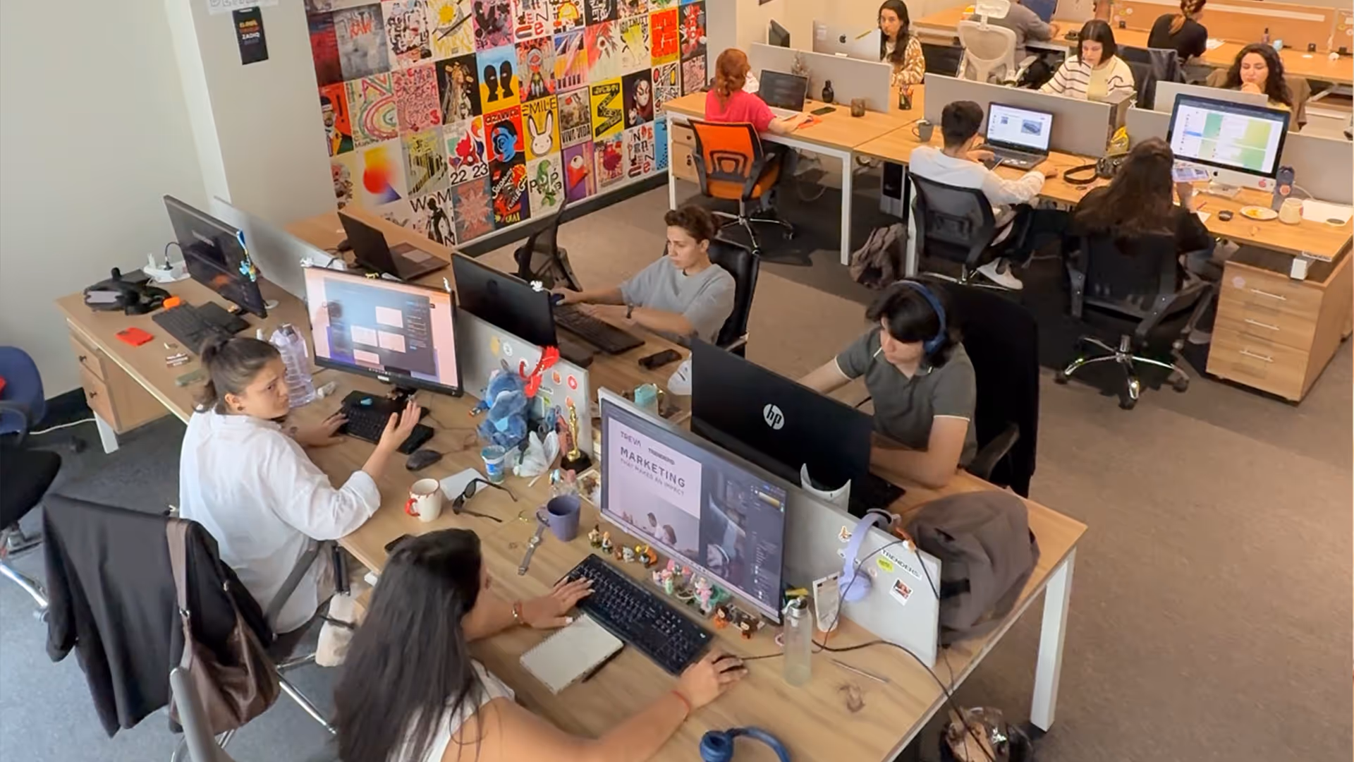 A group of people working on computers in an office.