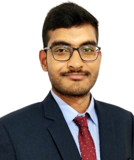 Formal headshot of Dr Vamsi Krishna Kommineni in suit and tie, neutral background.