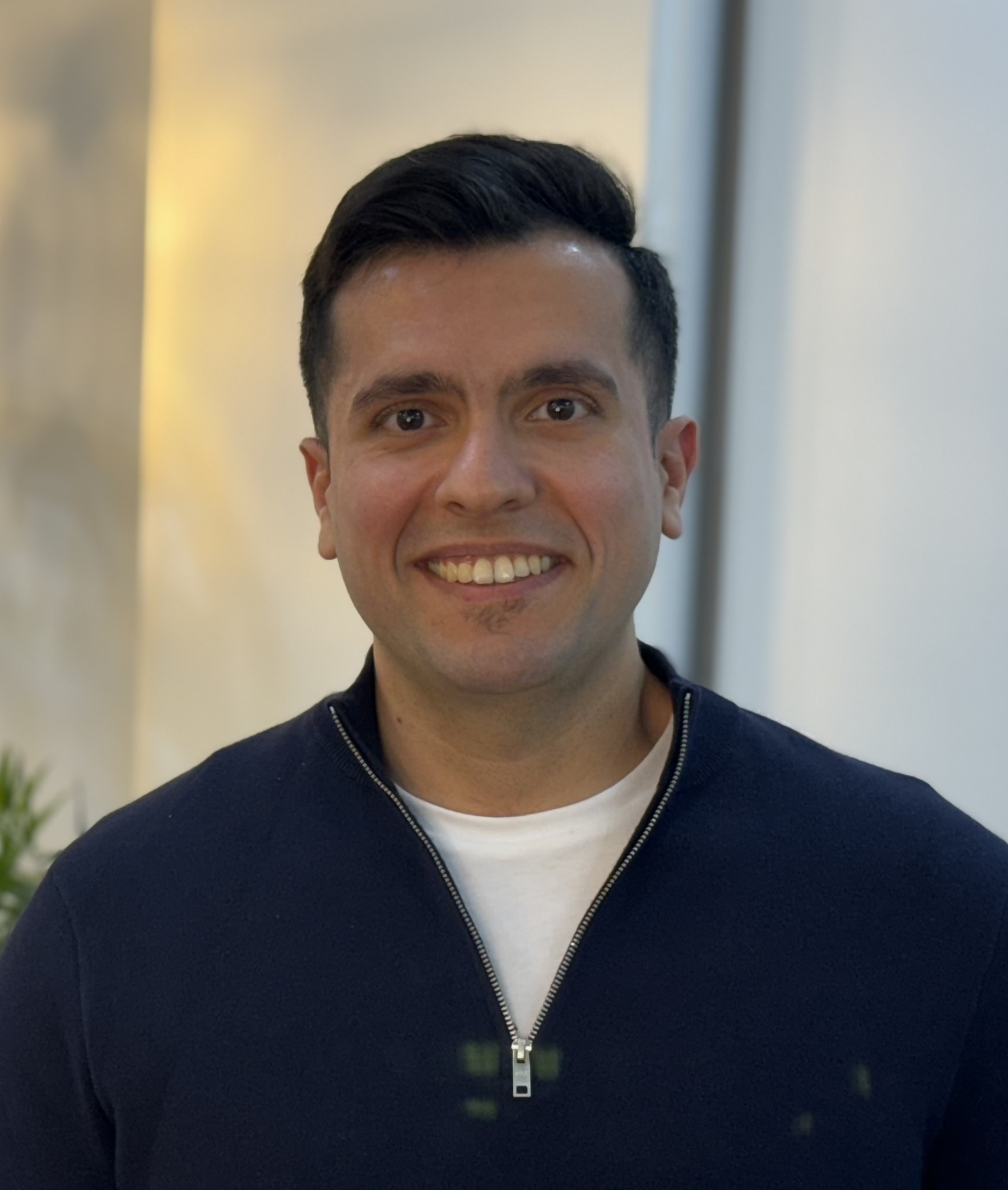 Head-and-shoulders photo of Dr Mehran Barzegari in navy jacket, dark hair, friendly expression