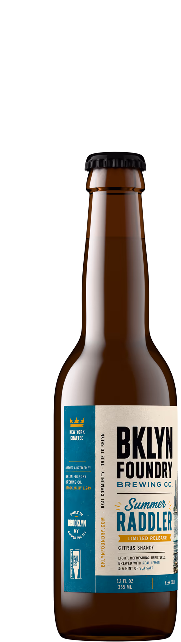 Citrus shandy beer bottle shot in amber glass with black crown cap, craft beer product photography