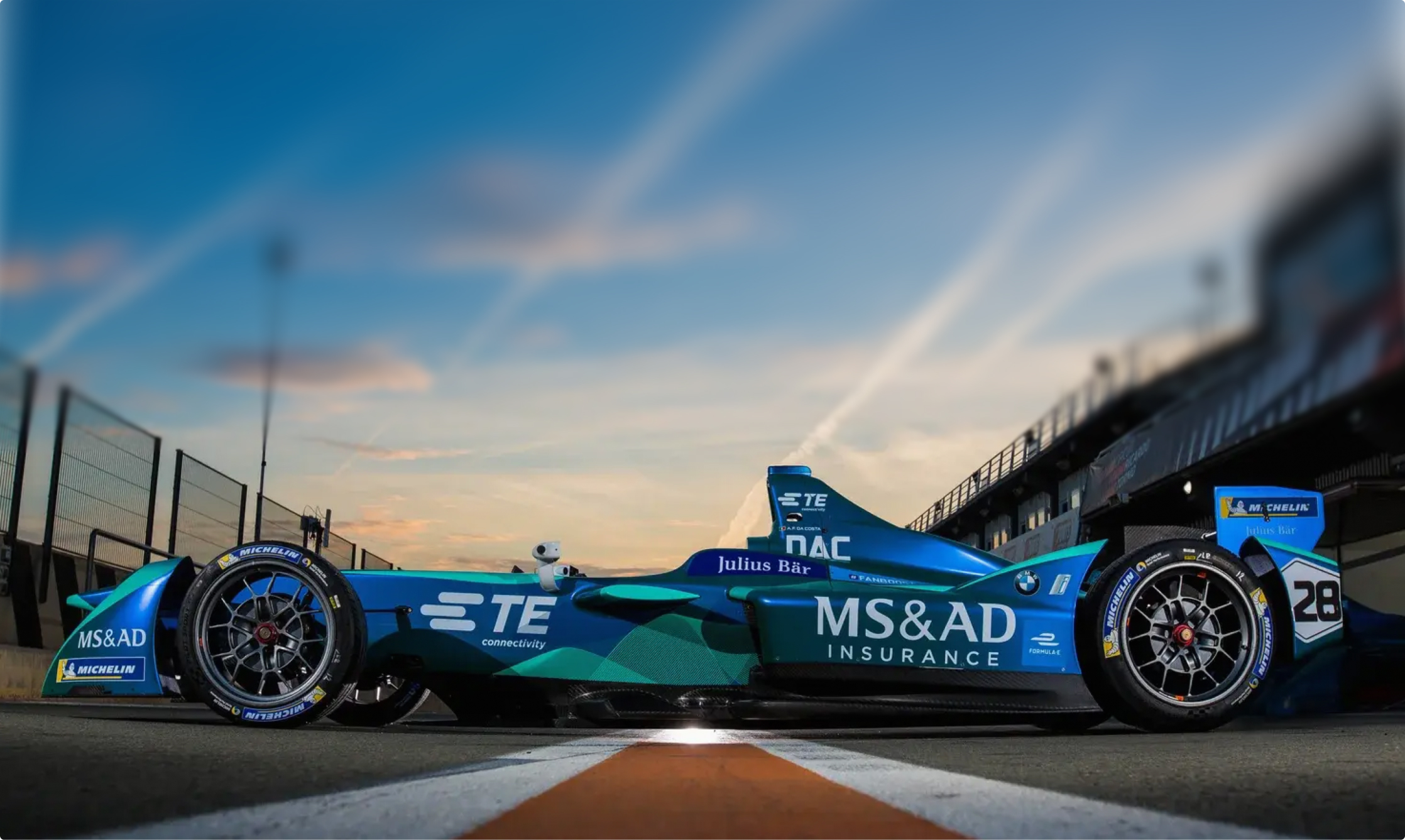 Blue and green Formula E racing car at Valencia testing.