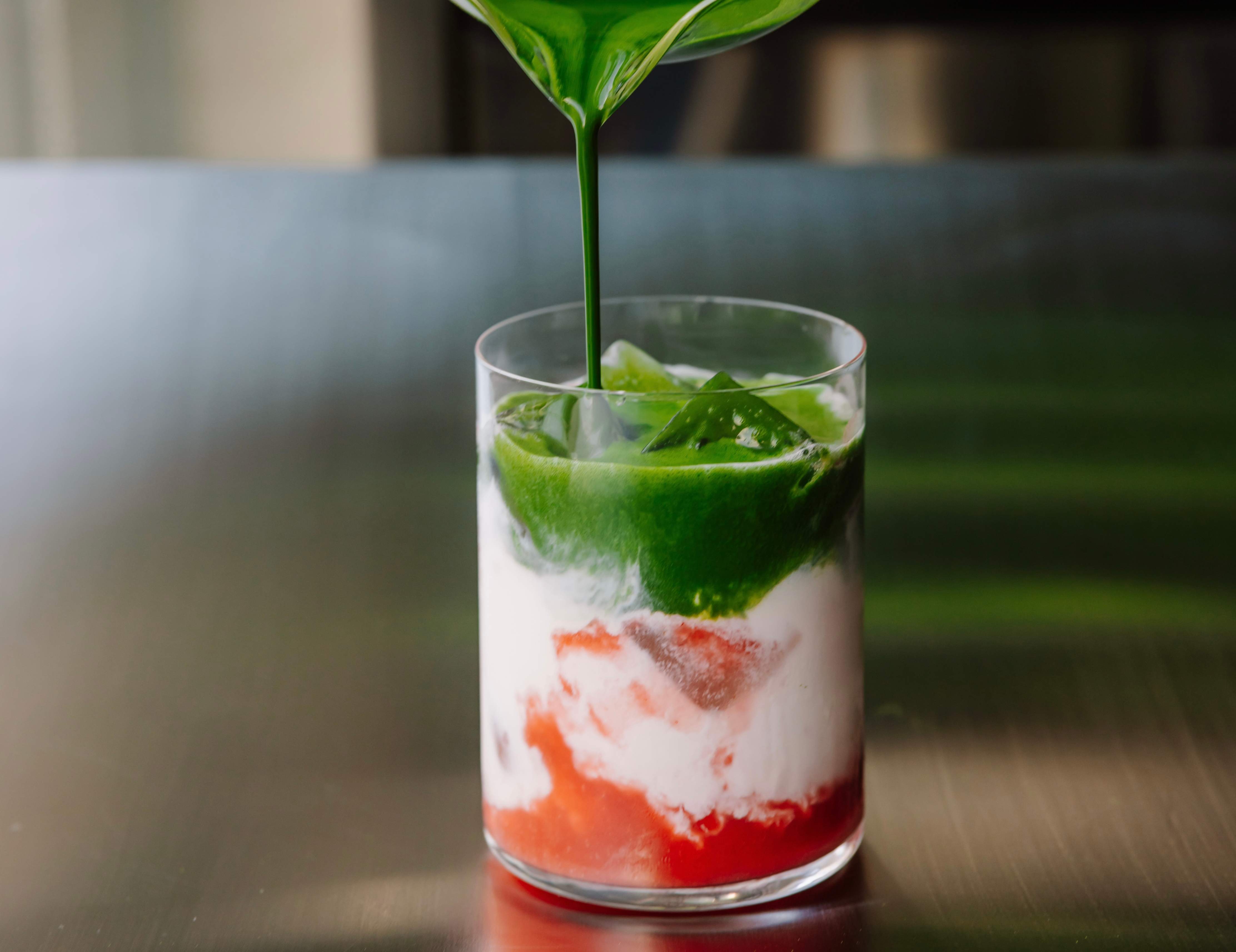 Strawberry iced matcha with layers of strawberry, milk and matcha