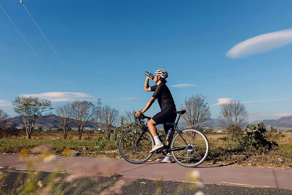 cyclist hydrating properly on a ride