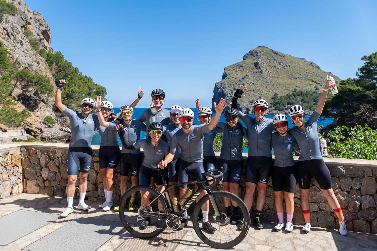 Group of cyclists hands up