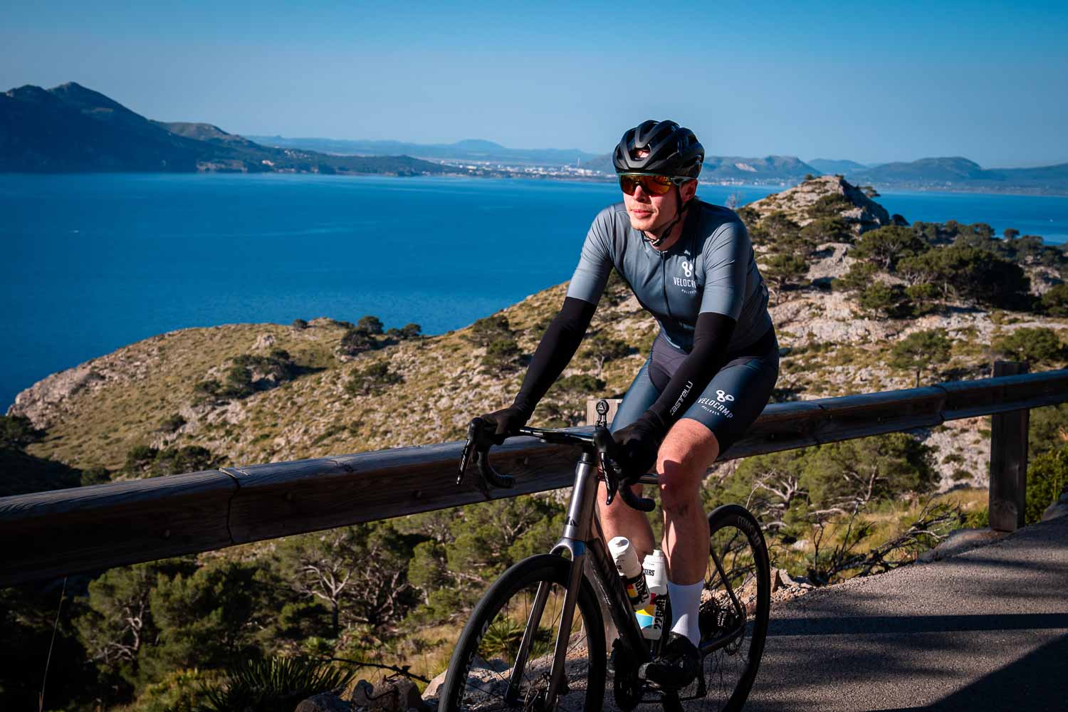 Happy cyclist ocean behind