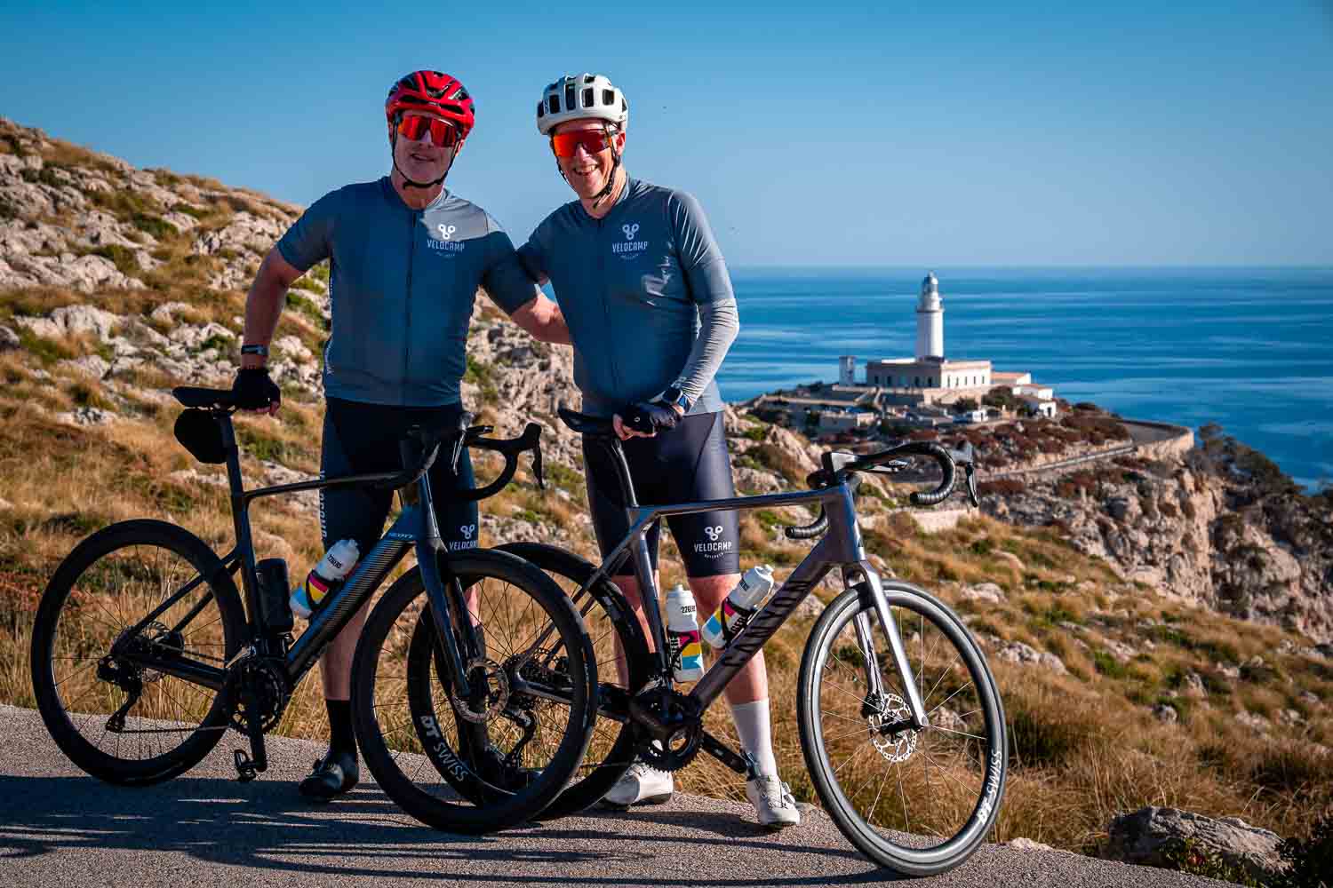 Two friends with the lighthouse behind