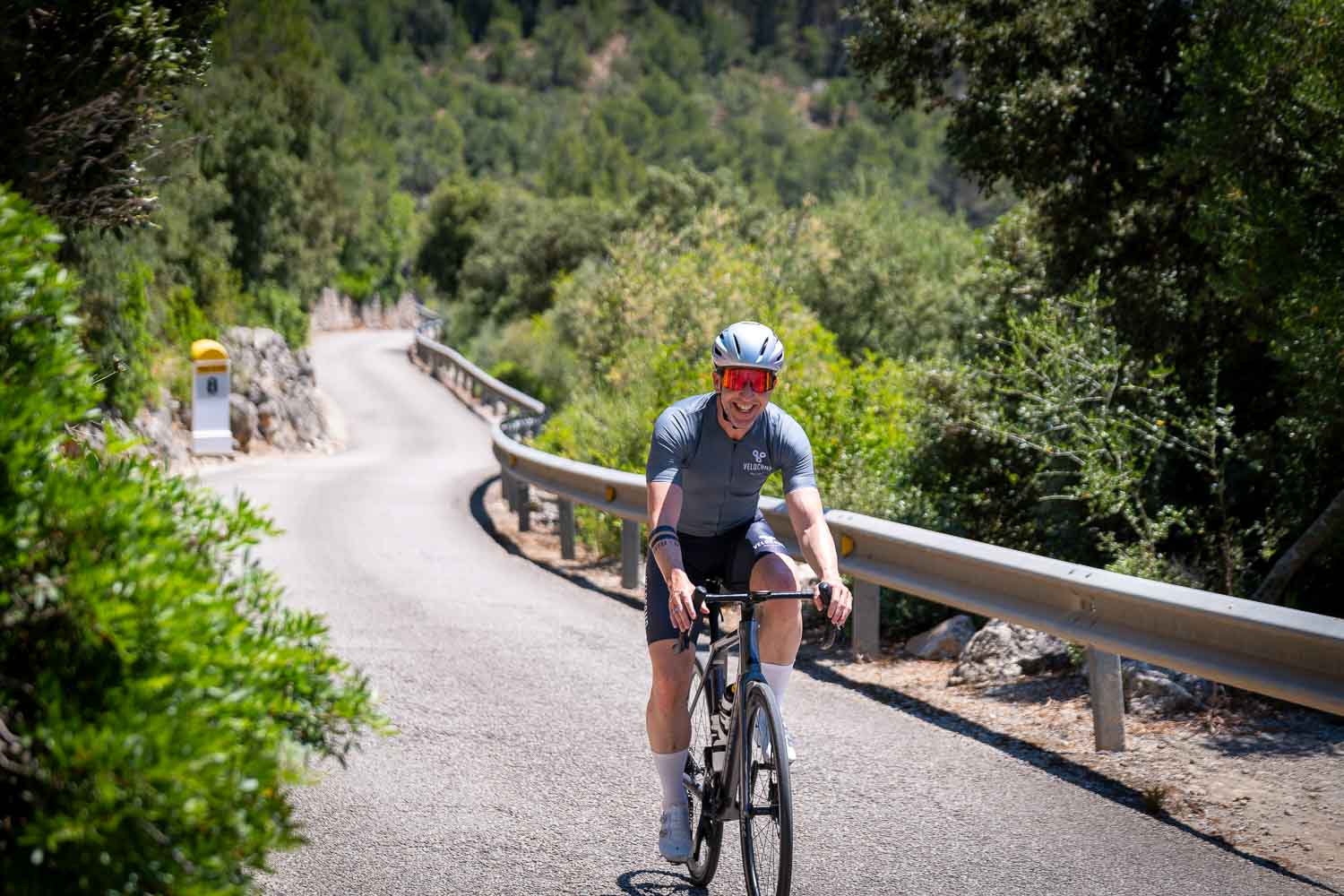 Smiling cyclist ascending