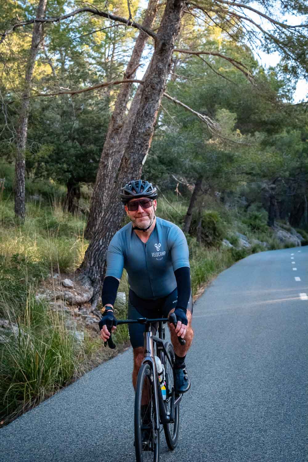 Cyclist standing and smiling