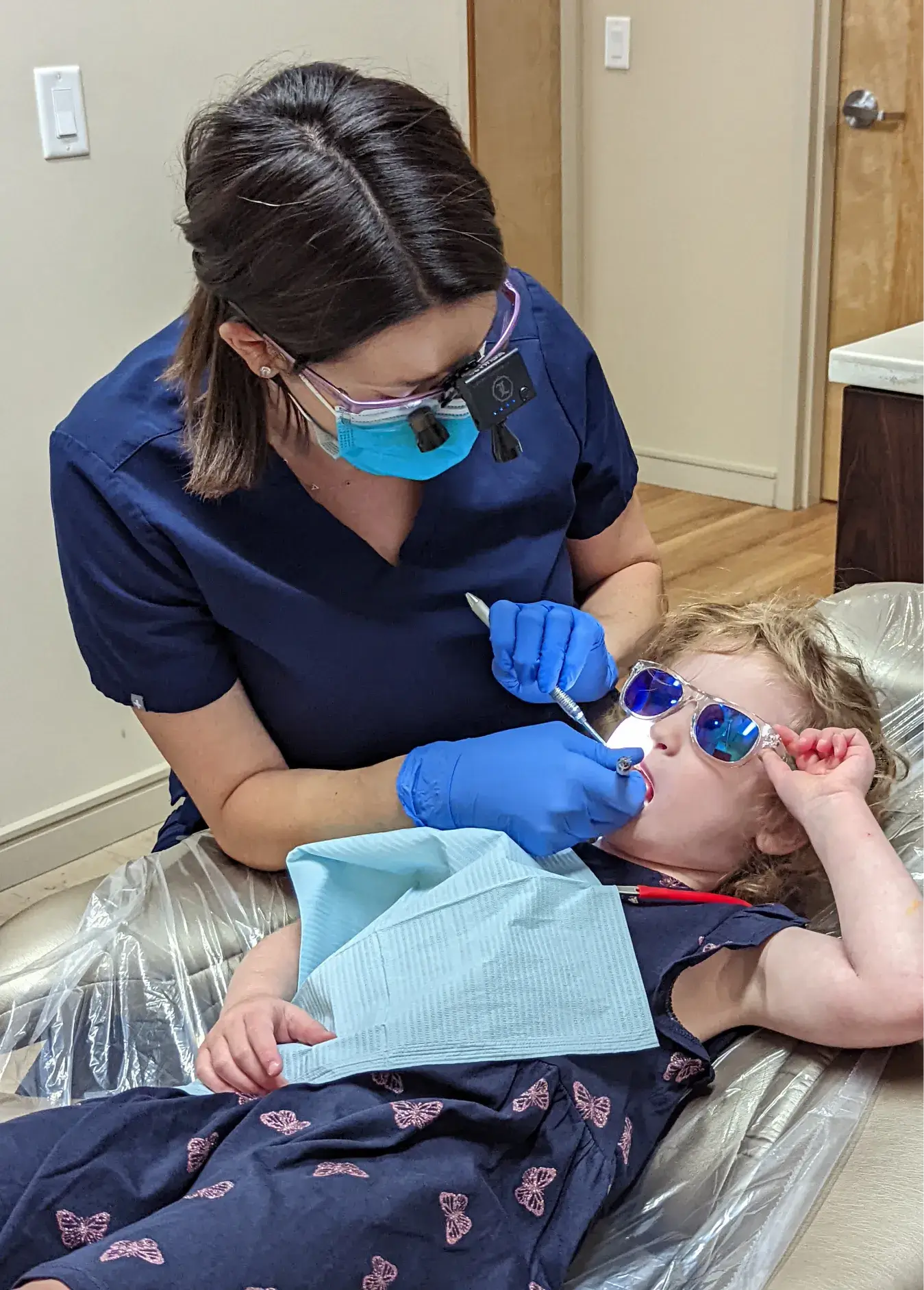 Dentist checking a girl's teeth