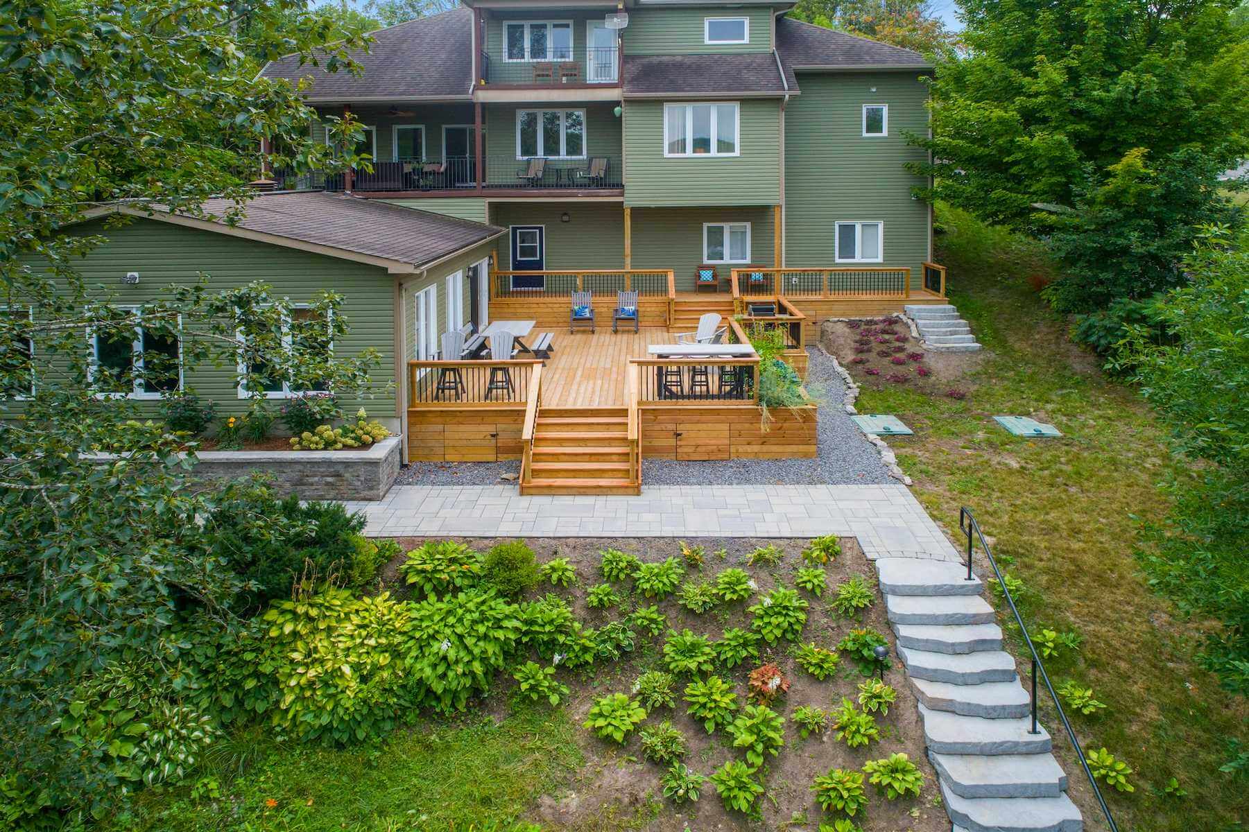 A stunning home exterior featuring a newly constructed deck, showcasing the impact of choosing top-quality deck materials for creating an inviting and functional outdoor living space